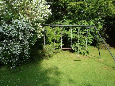 Der Garten des Ferienhauses mit Schaukel